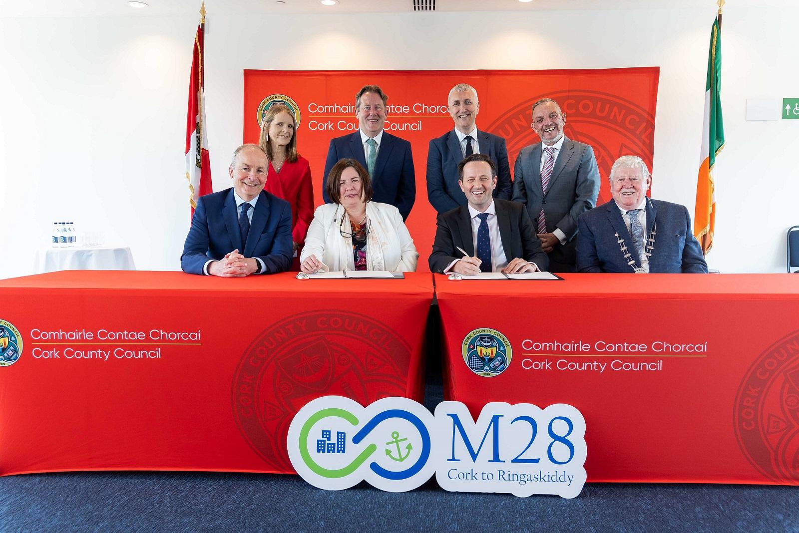 Pictured at the M28 Cork to Ringaskiddy Motorway contract signing seated left to right are: Taoiseach Micheál Martin; Moira Murrell, Chief Executive of Cork County Council; Alasdair Henderson, Executive Director, BAM Ireland; and Cllr Martin Coughlan, Deputy Mayor of the County of Cork. Standing are Geraldine Fitzpatrick, Transport Infrastructure Ireland; Minister for Transport, Darragh O'Brien; Padraig Barrett, Director of Service, Cork County Council and Minister of State, Jerry Buttimer.