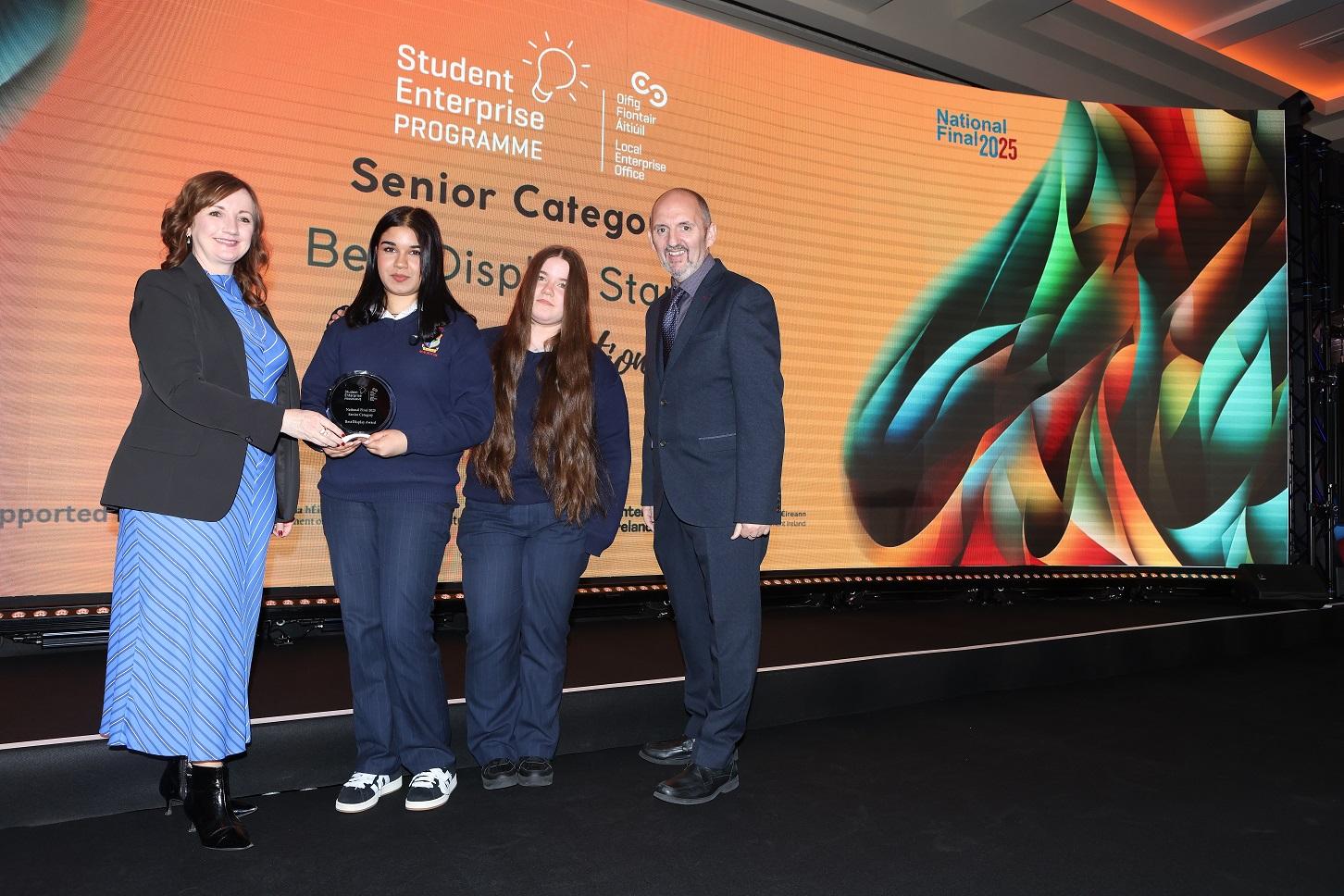 Students from South Cork have taken Best Display prize at this year’s Student Enterprise Programme National Finals. Pictured are St. Marys SEP Winners Muireann and Sinead pictured on stage with Enterprise Ireland, Teri Smith & Head of Enterprise, Carlow, Kieran Comerford.